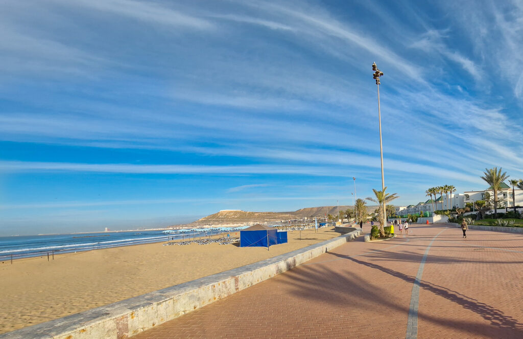 The beach of Agadir with the promenade and the Kasbah in the far distance