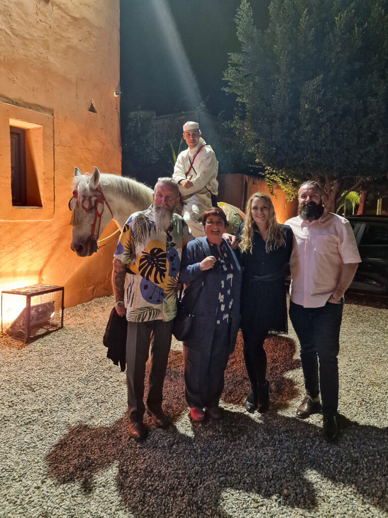 Luke and Kay with Luke's Mum and Dad standing in front of a horse with his rider at a Fantazia night at Chems Ayour Agadir