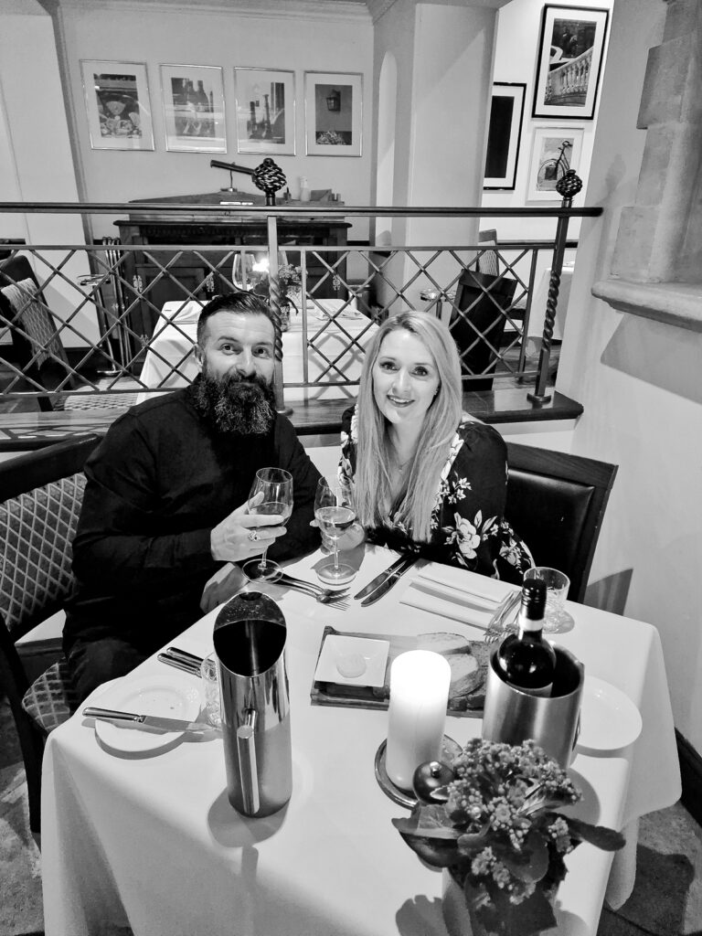 Luke and Kay at Dinner table holding wine glasses at the AA rosette restaurant in Kettering Park Hotel and spa