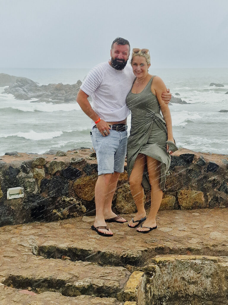Luke and Kay getting wet with rain on the flag rock in Galle fort Sri Lanka