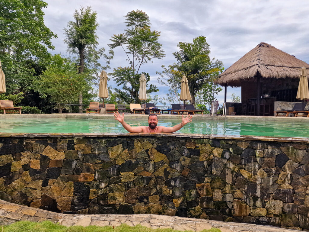 Luke in the pool with his hands up in the air happy at 98 Acres hotel Ella Sri Lanka