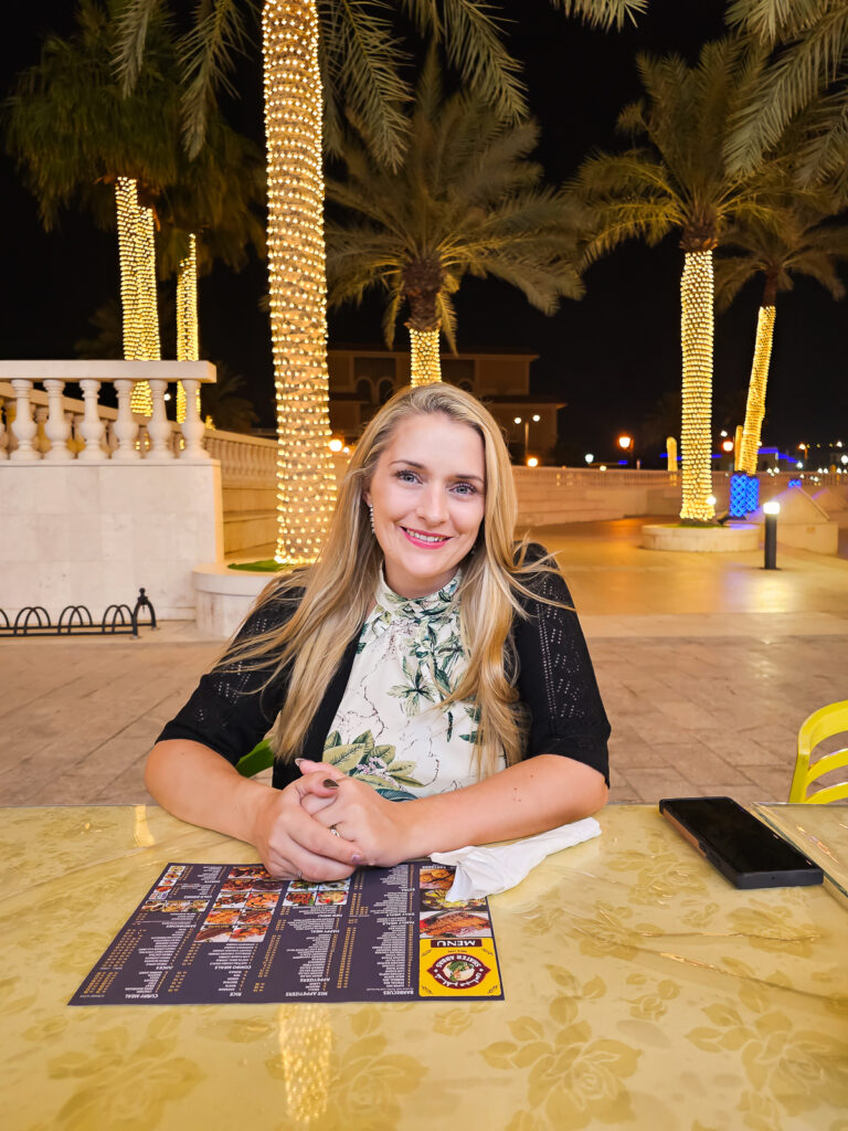 Kay sitting at the outside seating area at Shater Abbas The Pearl Qatar Doha